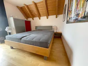 Kirschbaumbett mit grauem Leder auf dem Betthaupt, der Schubladenblende und den Füßen Kirschbaumbett mit grauem Leder auf dem Betthaupt, der Schubladenblende und den Füßen